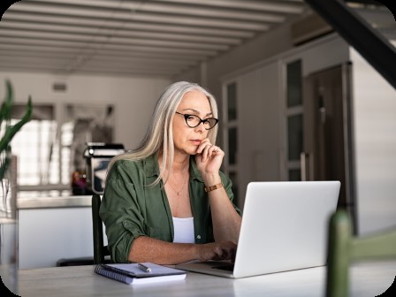 Woman in green sitting on laptop