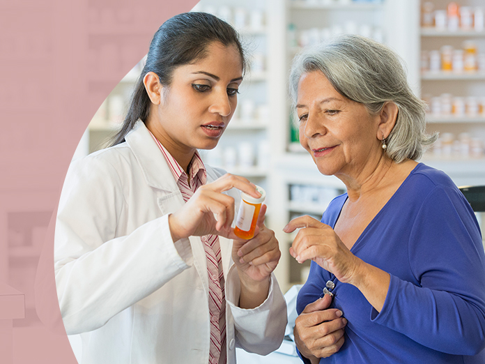 Woman in blue & doctor reviewing  medication bottle