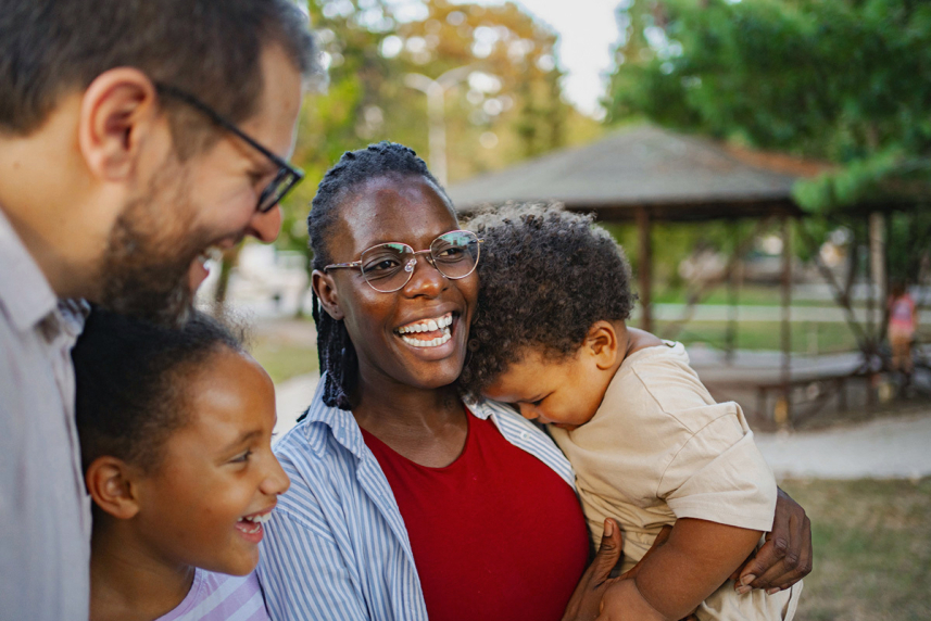 A family outside and laughing.