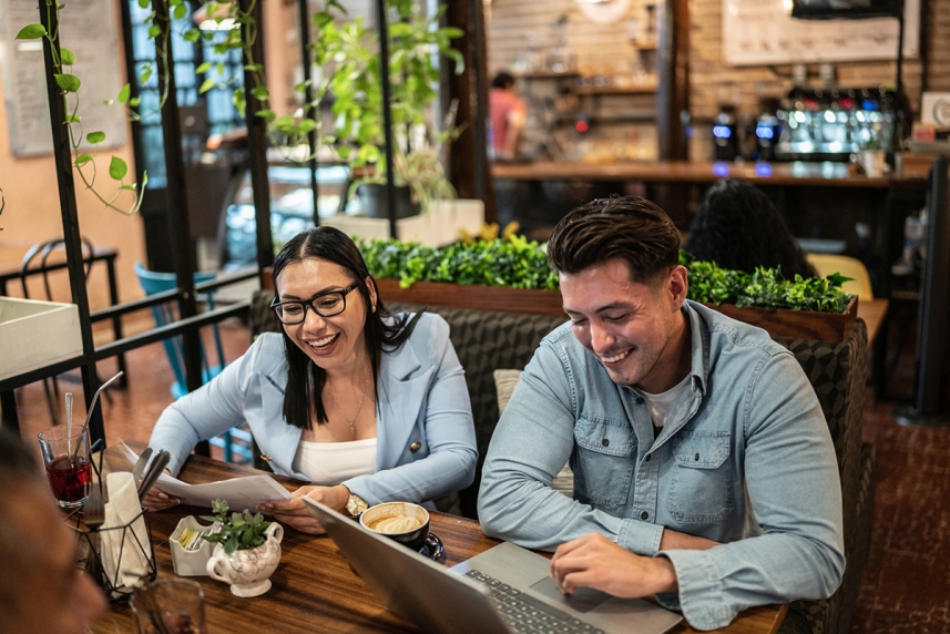 A man and woman looking at a laptop
