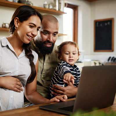 Parents with a child looking a laptop