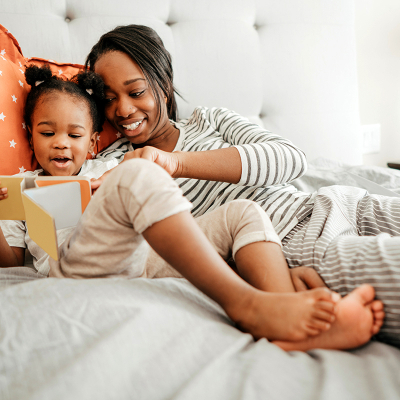 A woman and child reading a book 