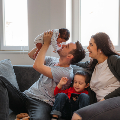 Parents and two children sitting on a couch