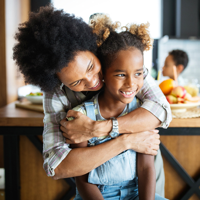A woman hugging a child at home
