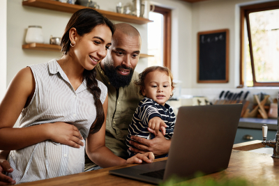 Parents with a child looking a laptop