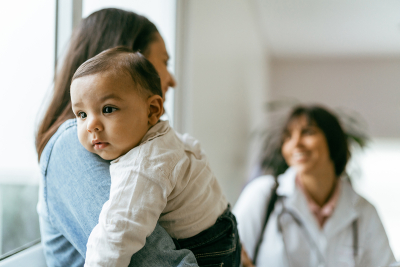 A mother with a new born on her shoulder