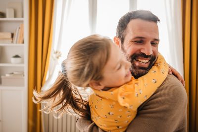 A man hugging his daughter