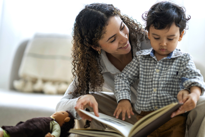 A woman and child reading a book 