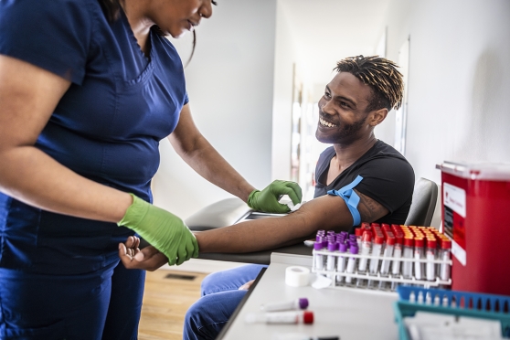 A young gets blood drawn by a nurse
