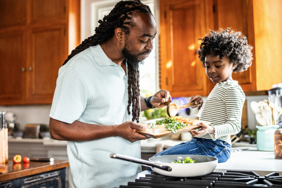 A parent cooking with their child.